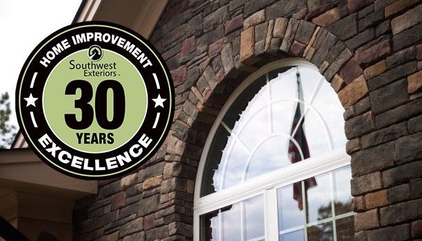 A home with brick siding and a rounded window. Southwest Exteriors logo saying "30 years, home improvement excellence" is on the left side.